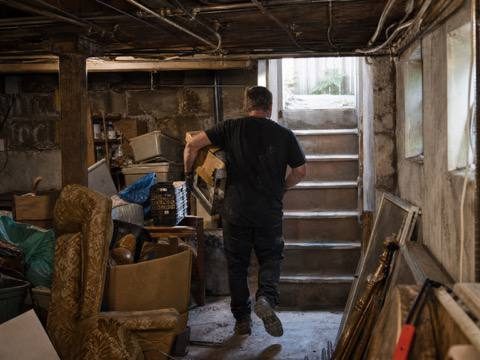 Crew clearing out a cluttered basement